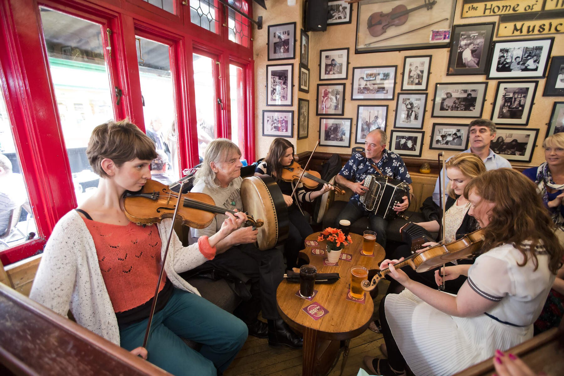 Traditional musicians listening and playing together at a session